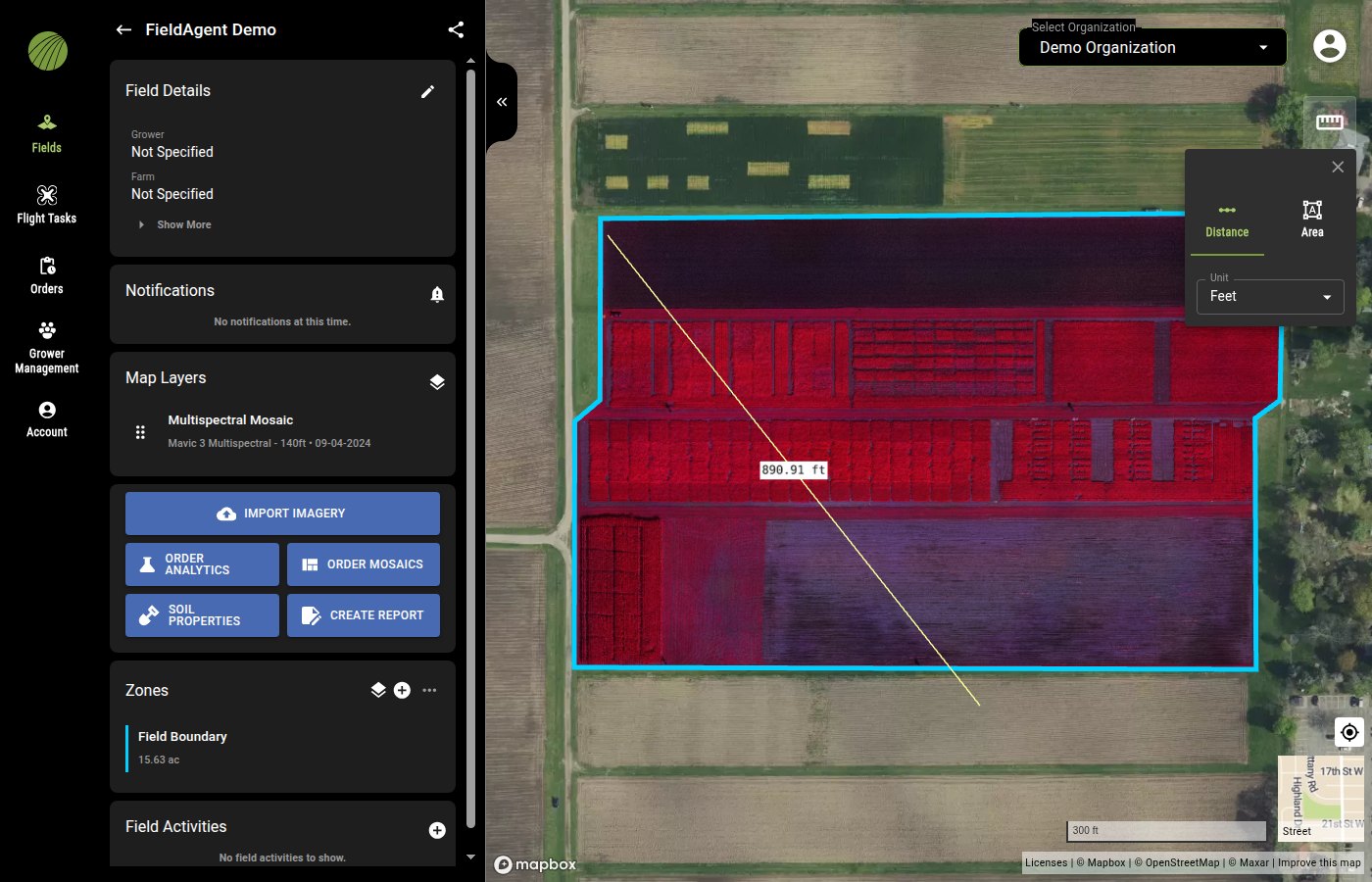 The measure tool open in the top-right corner of the map with the Distance tab selected and Unit set to Feet; a yellow line crosses the field with the label 890.91 ft